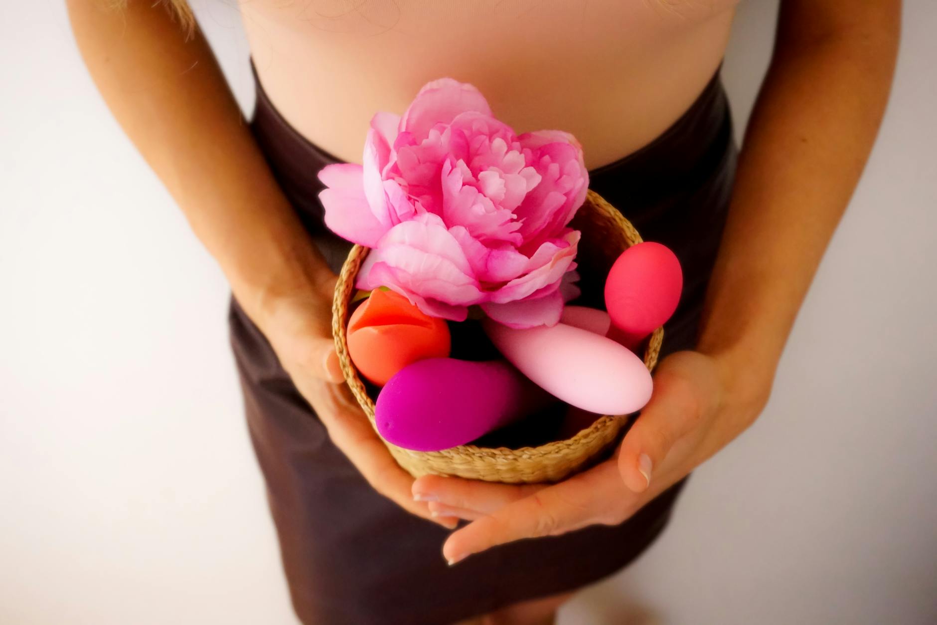 Woman holding clitoral vibrators, exploring renewed pleasure and sexual confidence